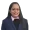 Portrait of a smiling woman in a navy blazer and pink shirt facing the camera