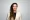 Jenni Monkiewicz The Portfolio The Portfolio Portrait of a woman with long dreadlocks in a cream blazer against a light gray background