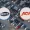 Aerial view of a crowded car lot with two circular logos Copart blue border and ACV Auctions orange border