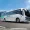 GreenCell Mobility Raised ₹330 Cr Expand Electric Bus The Portfolio White NuGo tour bus driving on a mountain road under a clear blue sky The Portfolio Magazine watermark in the top left corner