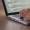 Person typing code on a laptop with a visible code editor logo reads The Portfolio in the corner